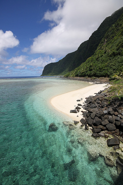 Turquoise water, green mountains and white sand in American Samoa